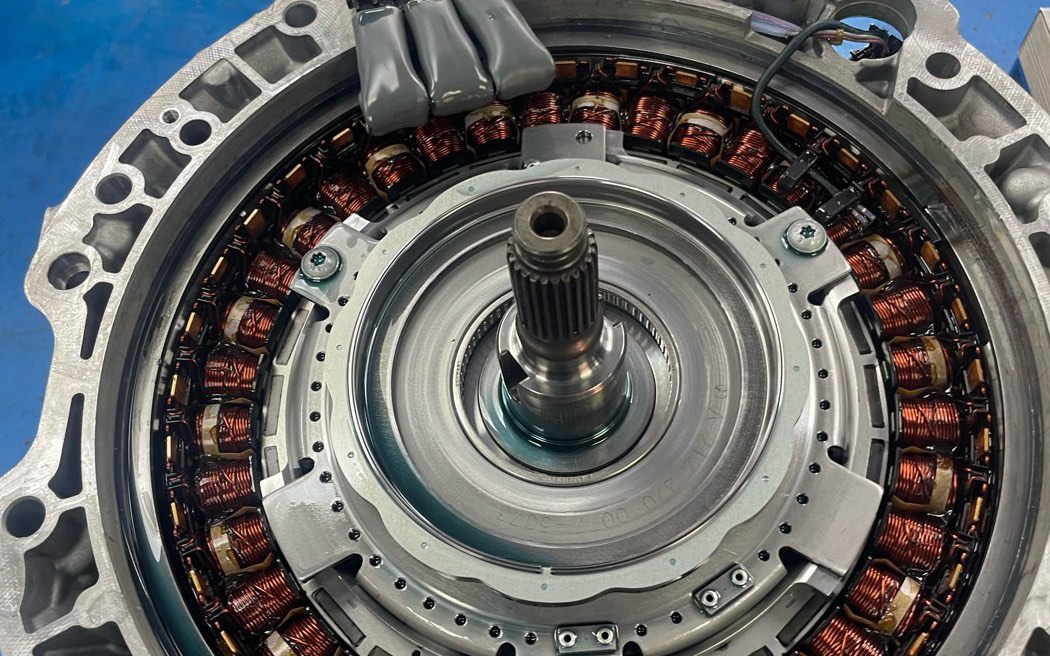 A ZF 8HP hybrid unit opened up, showing the copper windings of the electric motor stator around the input shaft